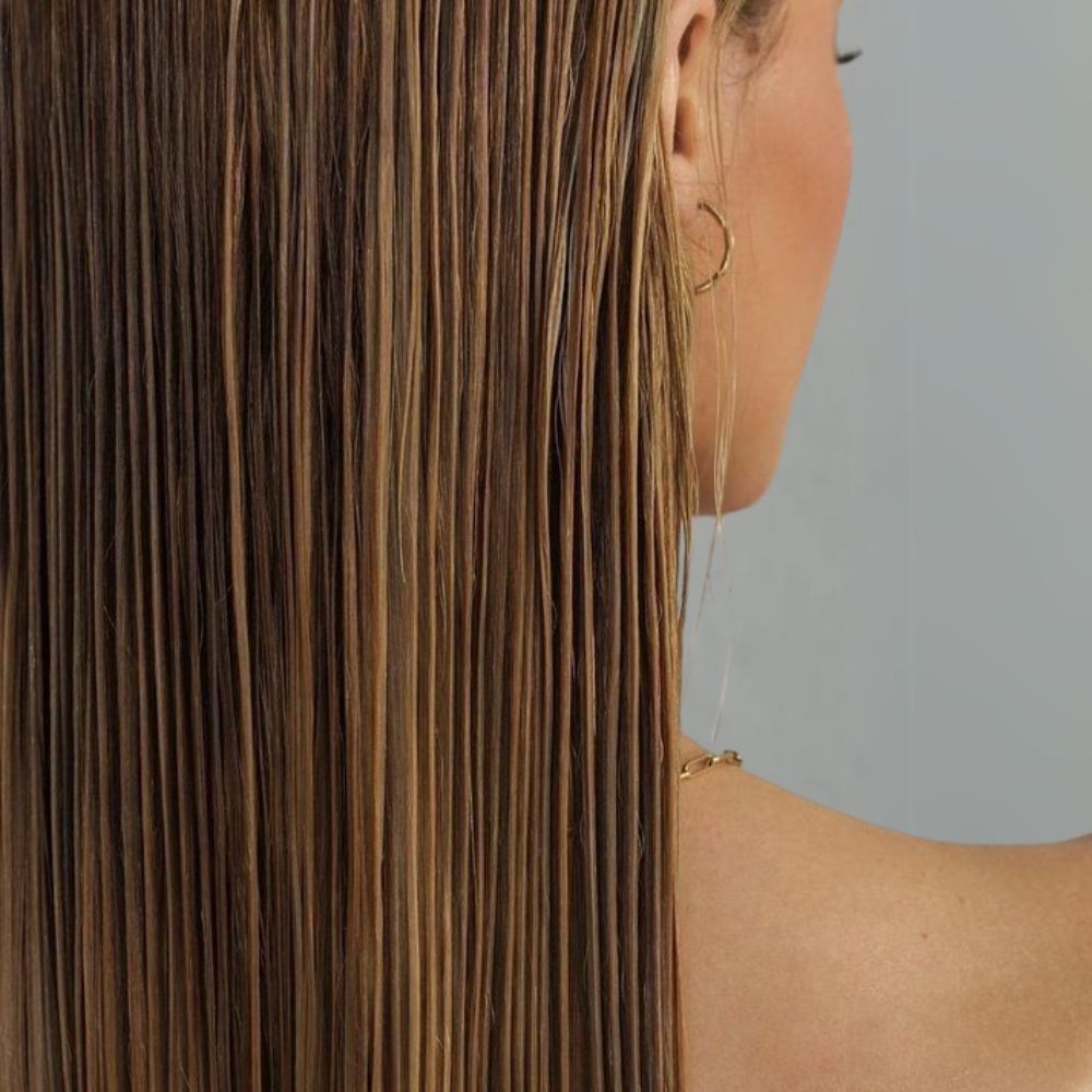 Woman applying Hair Fibre Locking Spray